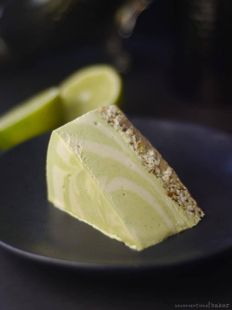 a slice of a grain-free and oil-free raw vegan coconut lime cheesecake
